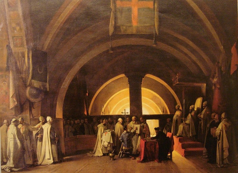Painting of dozens of men in white robes in a domed chapel. A young man with short black hair and dark blue robe is kneeling on a stool in the center, and pointing at something in a large open book which is being held by one of the white-robed men. Painting of dozens of men in white robes in a domed chapel. A young man with short black hair and dark blue robe is kneeling on a stool in the center, and pointing at something in a large open book which is being held by one of the white-robed men.