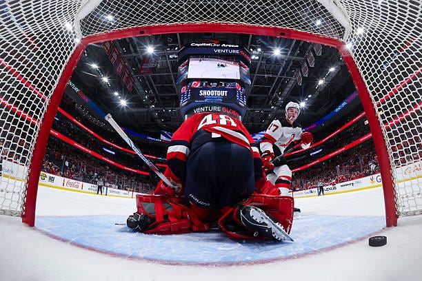 Simon Nemec of the New Jersey Devils scores a goal against Logan Thompson of the Washington Capitals during the shootout in the game at Capital One...