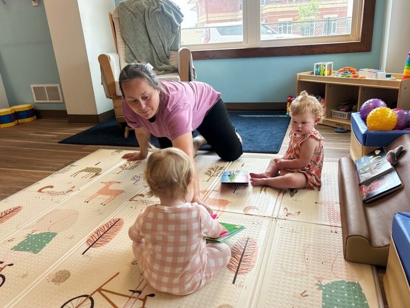 An employee at Cubby’s Childcare Center in Bridgeport, West Virginia, plays with two infants in July. A bipartisan group of state lawmakers say it’s time to rethink the nation’s fragile childcare system. (Photo by Amelia Ferrell Knisely/West Virginia Watch) An employee at Cubby’s Childcare Center in Bridgeport, West Virginia, plays with two infants in July. A bipartisan group of state lawmakers say it’s time to rethink the nation’s fragile childcare system. (Photo by Amelia Ferrell Knisely/West Virginia Watch)