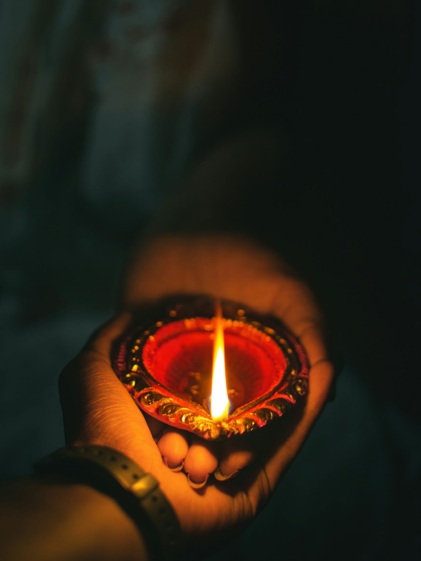 A small flame cradled in cupped hands