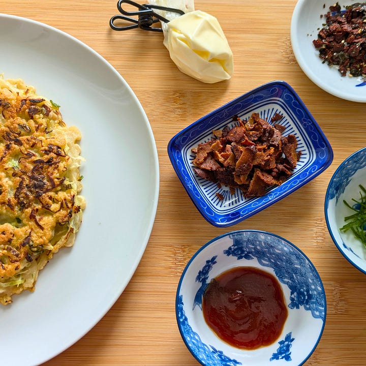 First image: cabbage being folded into the batter. Second image: a flat lay of a cooked okonomiyaki surrounded by toppings and sauces, ready to finish.