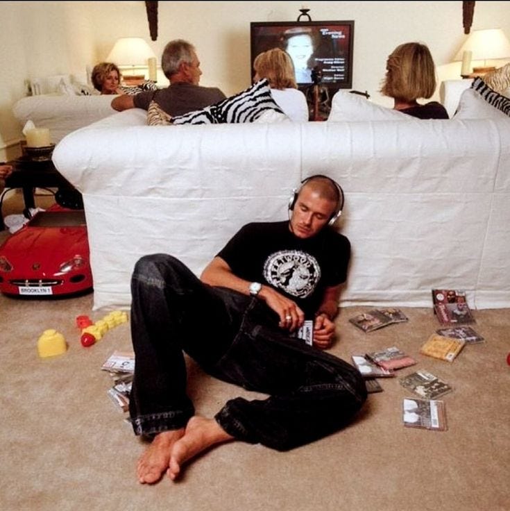 This may contain: a man sitting on the floor surrounded by other people This may contain: a man sitting on the floor surrounded by other people