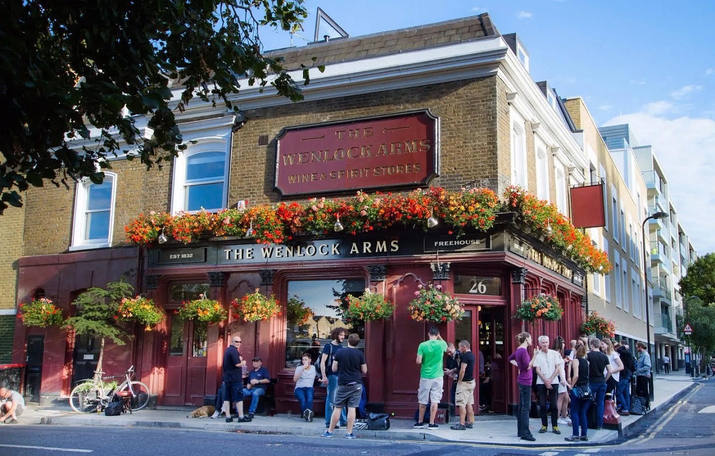 A decidedly not wintery/festive Wenlock Arms - corner pub bathed in sunshine, hanging baskets in full bloom and happy punters drinking on the pavement