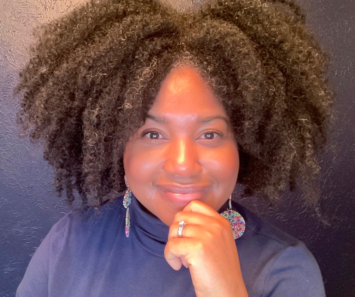 me, in a blue turtleneck, with a thicker mane of hair