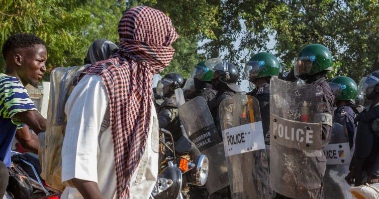 Protesters approach Cameroonian police officers as they gather in Garoua on October 26, 2025.
