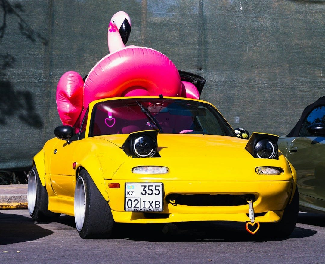 a yellow car with a red hood