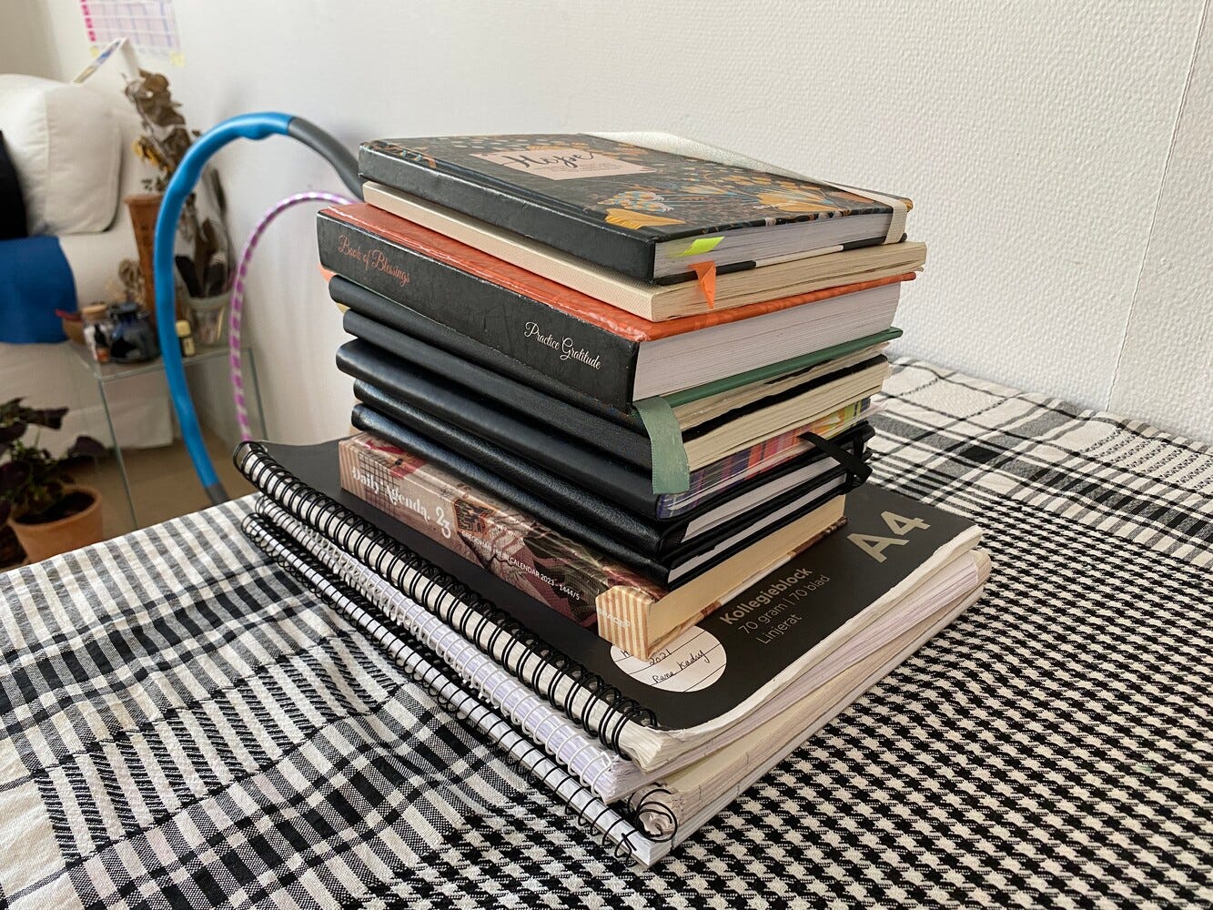 photo of a pile of notebooks and diaries on a table. 