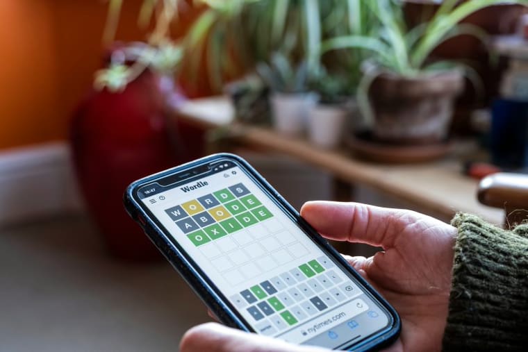 A woman plays Wordle on her smartphone on April 21, 2022 in Birmingham, U.K.