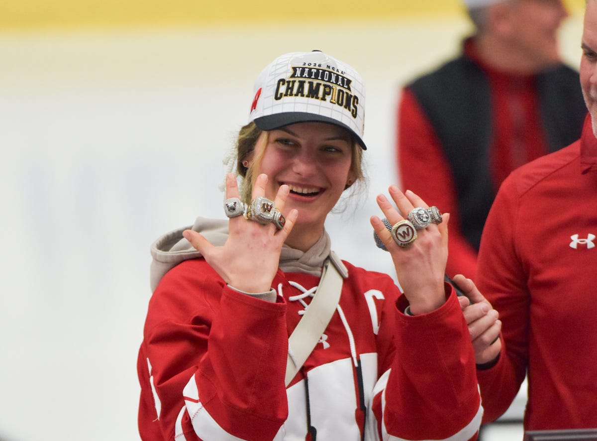 Lacey Eden holds up both of her hands covered in rings