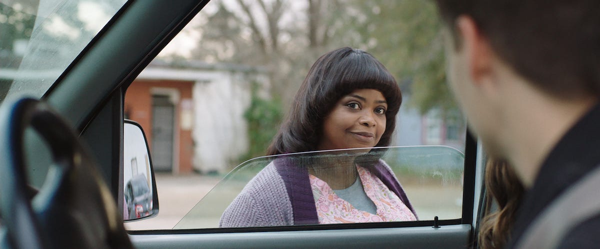 MA standing outside Andy's car, looking at him through the open window.