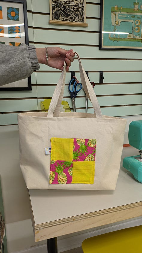 a muslin with alteration notes, an in progress quilt, a finished tote bag