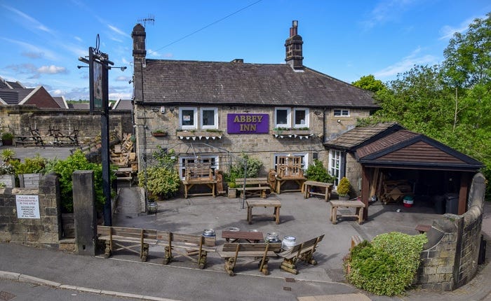 Blue skies behind the Abbey Inn, with its carpark out front Blue skies behind the Abbey Inn, with its carpark out front