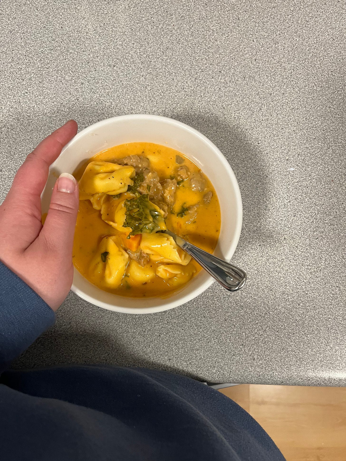 Melissa holding a bowl of creamy tortellini soup