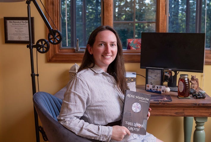 author Tara Lynne Groth holding her book ROSE WINDOW