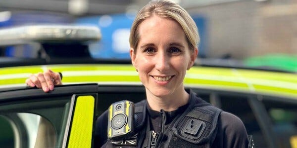 Inspector Rosie Emery next to an Essex Police car