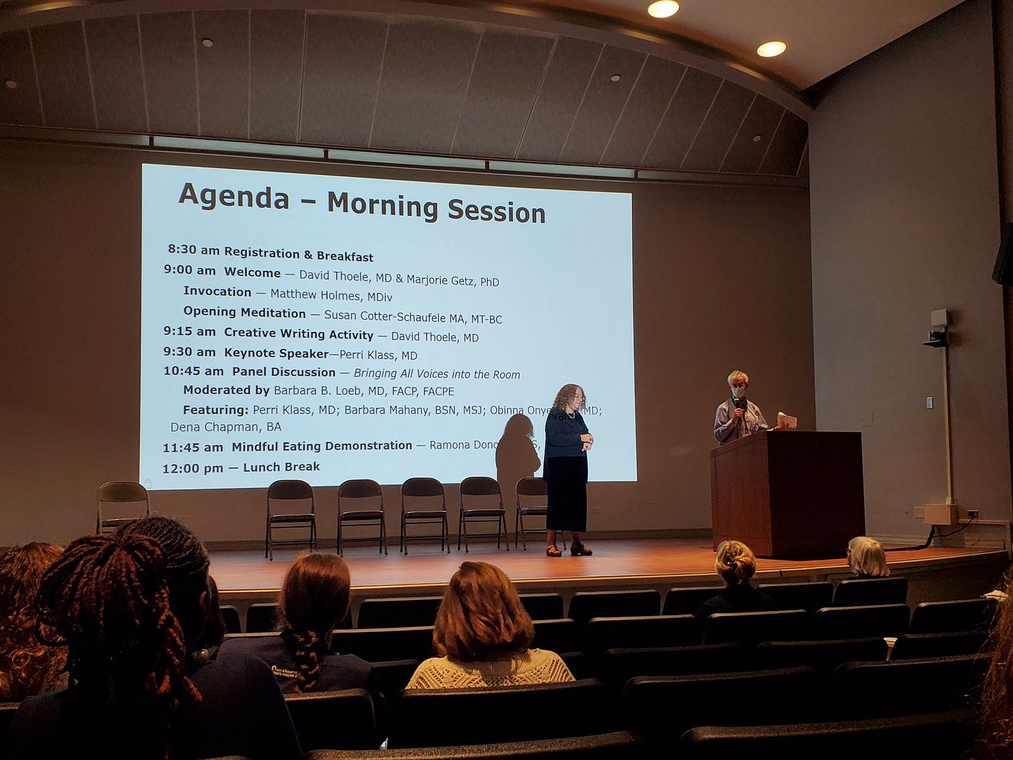 Morning agenda with two presenters on a stage