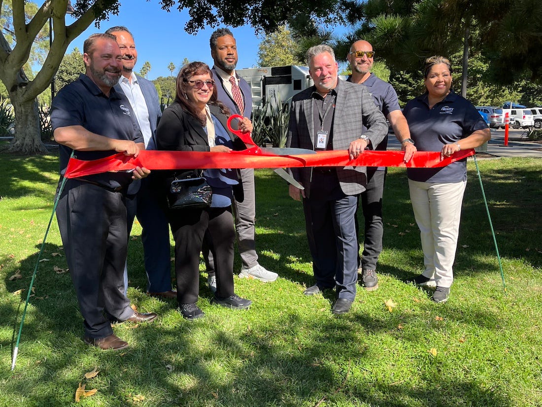 Oceanside City Manager Jonathan Borrego, second from left, and Mayor Sanchez, with scissors, celebrate the city’s partnership with representatives from SiFi Networks and Motive Construction in November to buildout a nearly citywide all-fiber high-speed internet network. Courtesy City of Oceanside