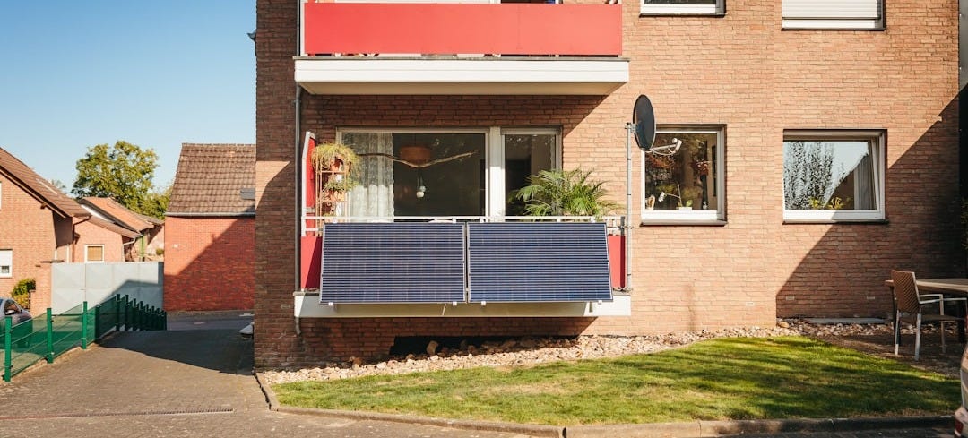 Balcony with solar panels on brick building Balcony with solar panels on brick building