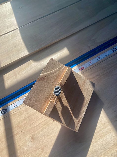 Photo of a miter station with an inlayed T-track and measuring tape, along with a custom stop block. Also a photo of two knobs that lock the flip-top carriage in place.