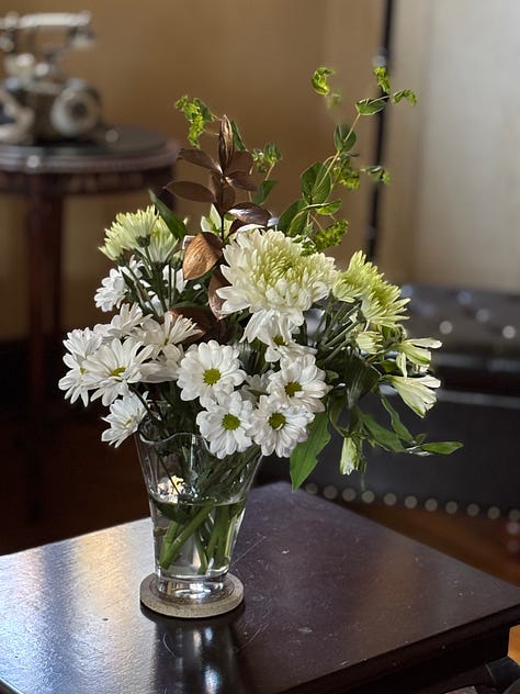 A vase or yellow, pink and red roses.. A vase of pink. A vase of assorted white flowers.