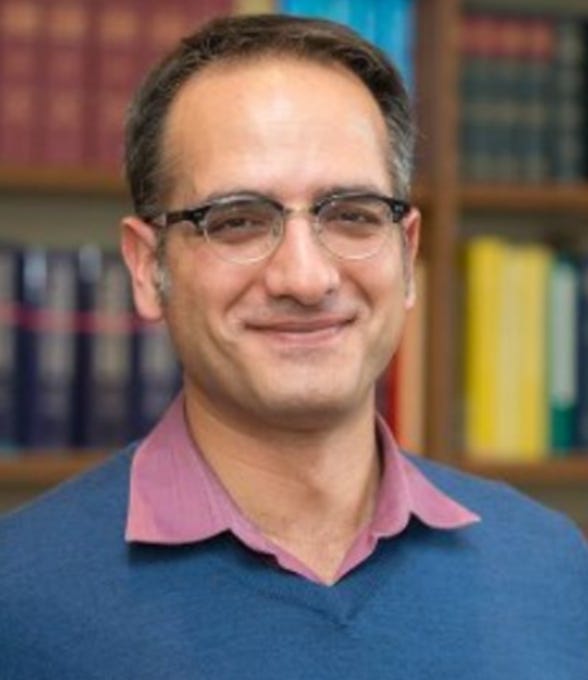 First image shows a man with glasses and short hair smiling, wearing a blue sweater over a pink collared shirt, standing in front of bookshelves filled with books of various colors. Second image depicts three masked individuals in black clothing, two wearing keffiyehs, standing behind a large banner with Arabic text reading الانتفاضة للطلاب meaning Intifada for Students, in a building interior with ornate architecture.