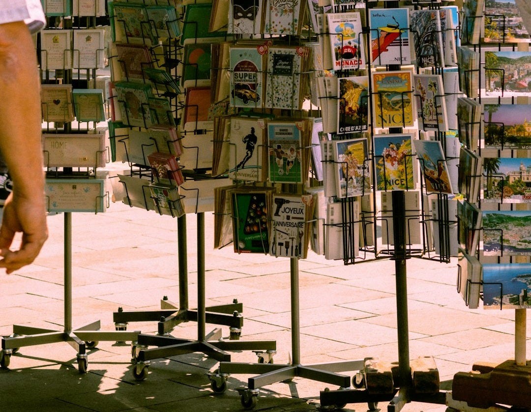a man standing next to a display of magazines