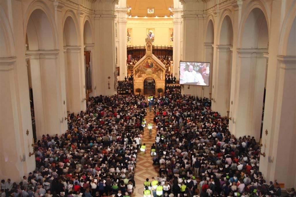 The Porziuncola church inside a church in Assisi., with a large crowd attending. The Porziuncola church inside a church in Assisi., with a large crowd attending.