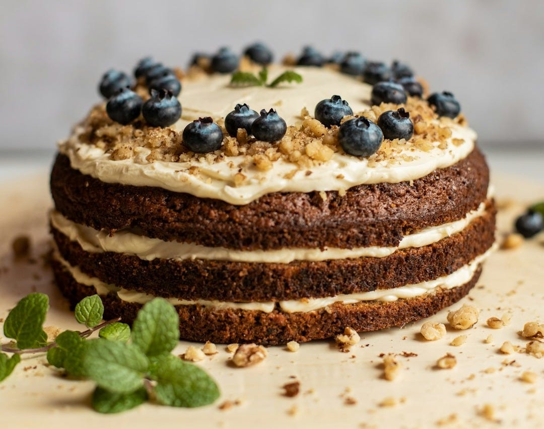 brown and black pastry with blue berries on white ceramic plate