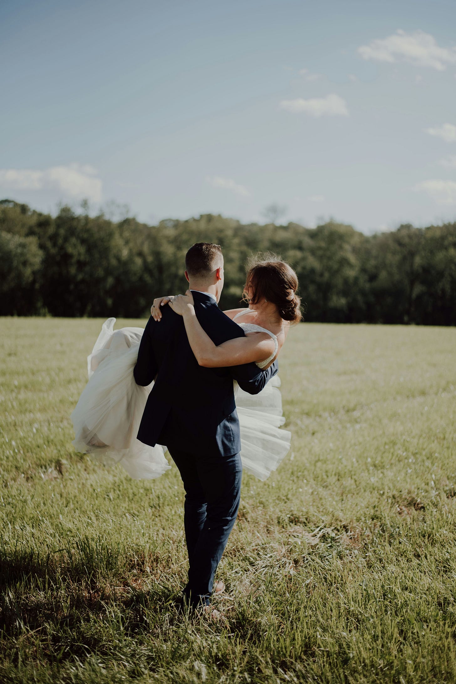 a bride being lifted by a groom