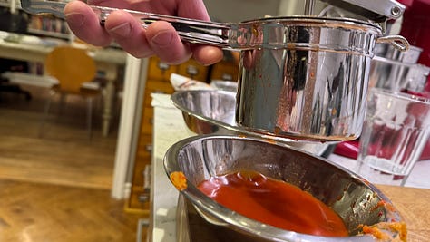 The photos  1) A shot of the hopper of a potato ricer, full of kimchi. 2) The ricer squeezing kimchi juice into a bowl. 3) A cooling rack keeping dumplings separated in a pot of boiling water. 
