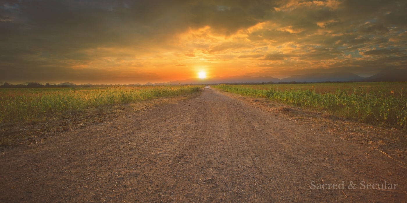 A wide, empty dirt road stretches into the distance at sunset, bordered by fields on either side. The sky is filled with warm golden light and soft clouds, creating a calm and reflective atmosphere. A wide, empty dirt road stretches into the distance at sunset, bordered by fields on either side. The sky is filled with warm golden light and soft clouds, creating a calm and reflective atmosphere.