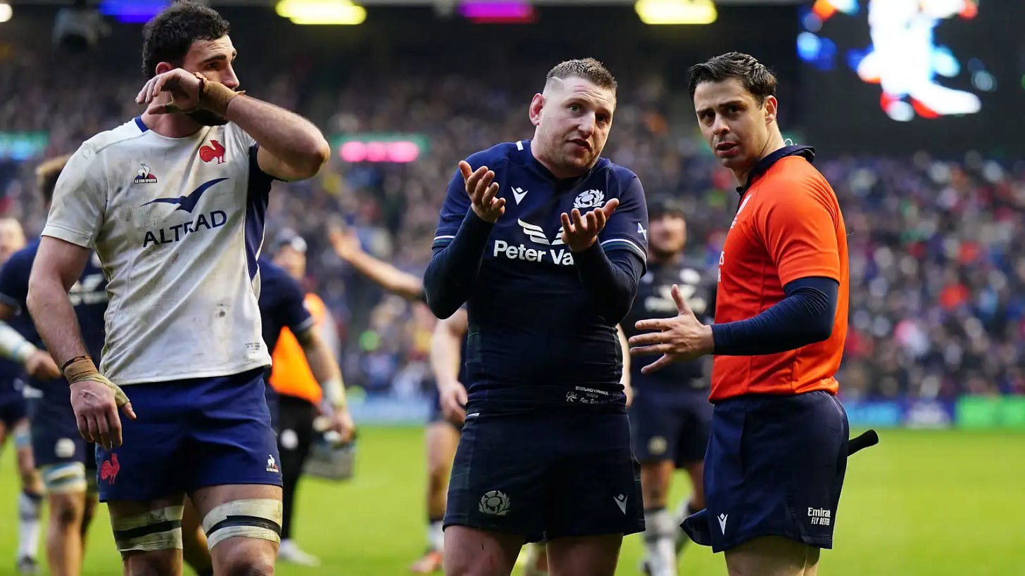 Scotland fly-half Finn Russell speaks to assistant referee Nika Amashukeli.