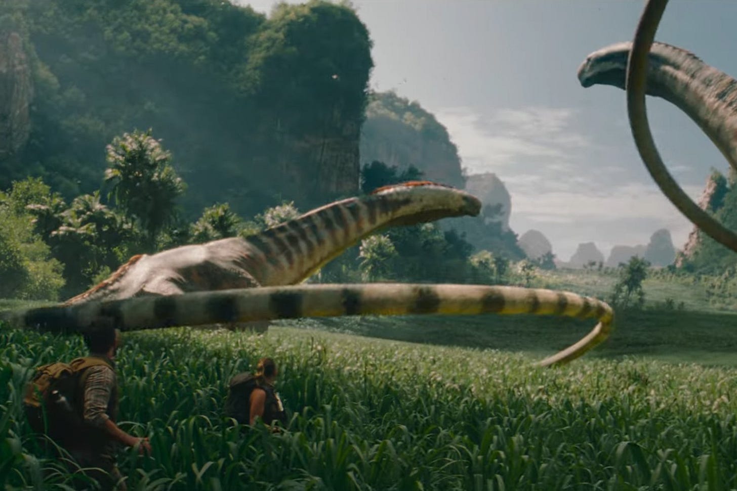 Bailey and Johannson look upon very very long-necked and long-tailed dinos