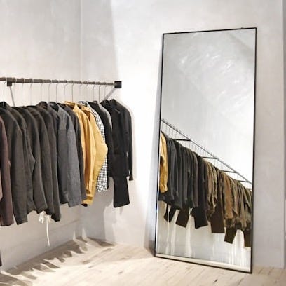 a room with a wall of clothes on the wall