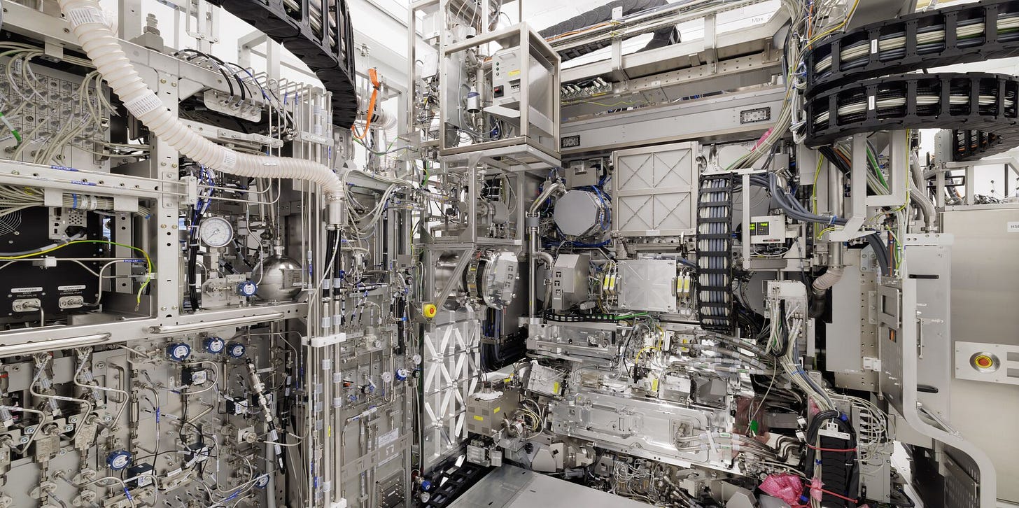 A wide editorial photograph of a semiconductor lithography clean room, illustrating the Dutch lithography chokepoint at the centre of the MATCH Act analysis in the Four Chokepoints series on The Control Layer