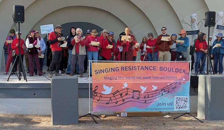 From top left, clockwise: a woman in a cowboy hat and a pink vest holds a sign reading "End The Trump Chaos Cruelty Corruption, Vote Blue in 2026, Impeach the Grifter-in-chief, a choral group with sound equipment and songsheets performs in a half-shell - they have a banner identifying themselves as the Singing Resistance: Boulder; a banner at a table for Soboco Indivisible, modeled after the American flag, reading Join Us, Stand Up, Fight Back; a large crowd of protesters gathered along the street.