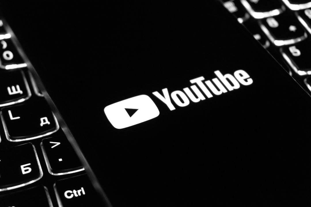 The youtube logo on a smartphone is visible. The youtube logo on a smartphone is visible.