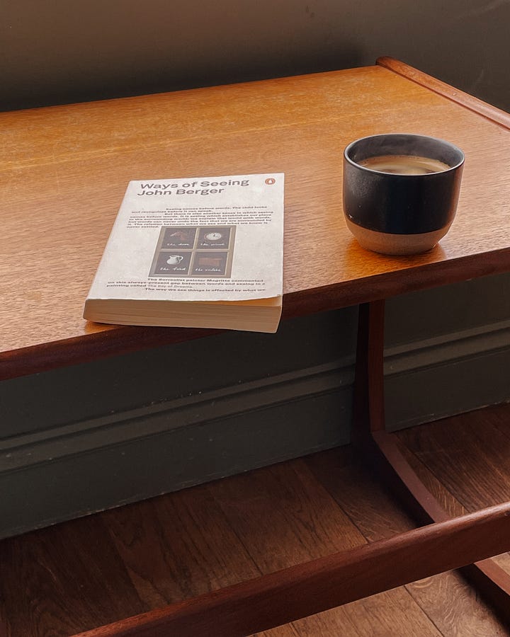 Image 1: Holding an almond croissant with a bite taken out, sitting cross-legged. Sand is visible below. / Image 2: The tide rolling in, gentle waves meeting the shore. / Image 3: Inside Tills & Company bookshop—books, tables, and people enjoying a slow moment. / Image 4: A coffee table in Tills with my book Ways of Seeing and a coffee cup resting on it.