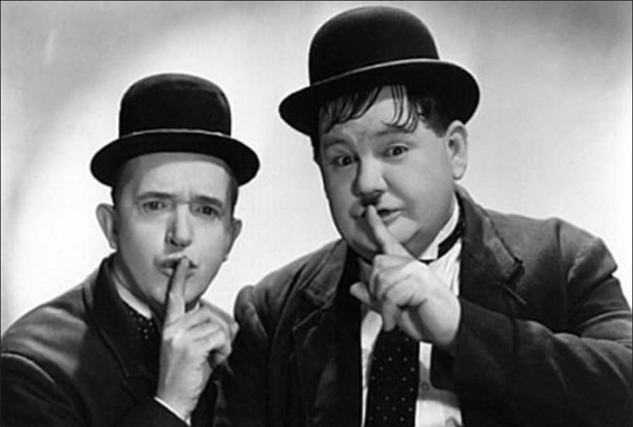 Abbott and Costello making a shh gesture