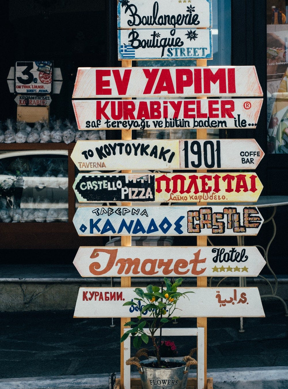 beige, red, and brown signages on beige stand at daytime beige, red, and brown signages on beige stand at daytime