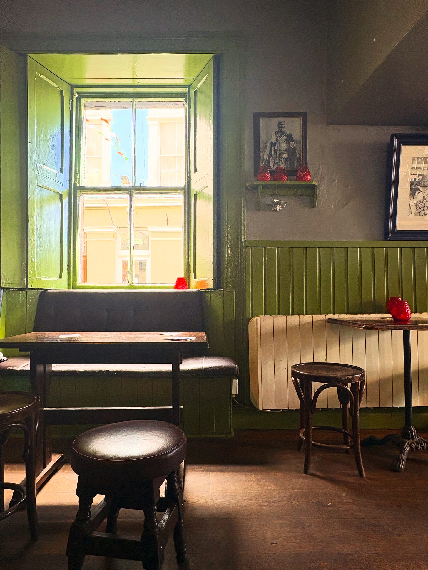a cozy pub sitting area and bright sunny window a cozy pub sitting area and bright sunny window