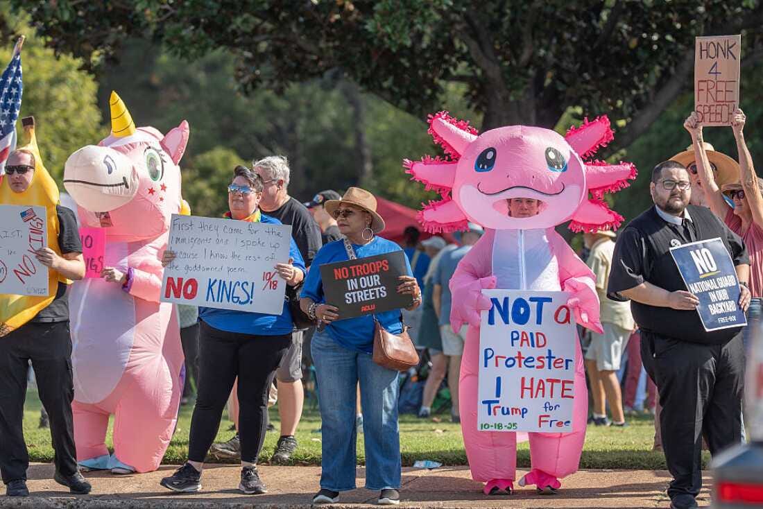 Protesters wear blow up costumes for the "No Kings" protest in Memphis, Tenn. on Oct. 18, 2025.