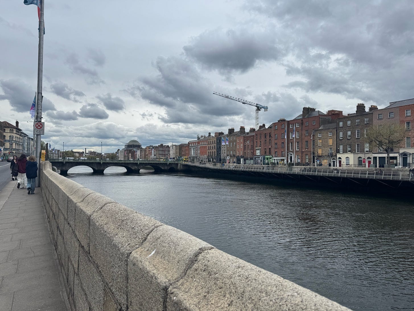 A grey day view of a river with old Dublin on the banks.