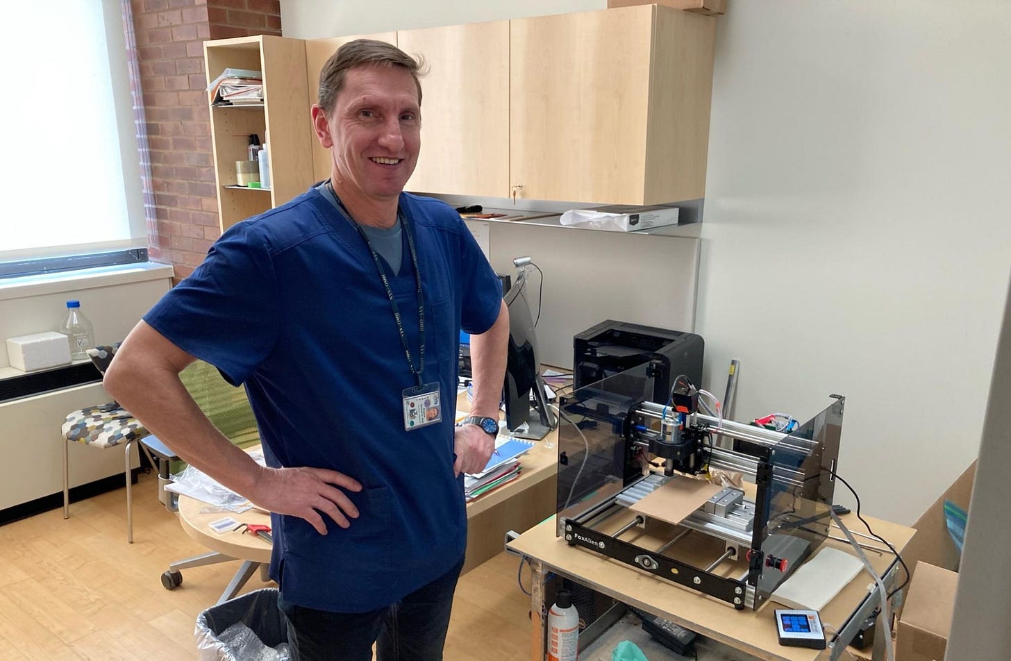 Eugene standing next to the CNC rig for cutting the brain slice into cubes. Eugene standing next to the CNC rig for cutting the brain slice into cubes.