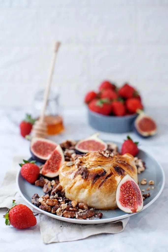 fresh sliced figs and walnuts topped baked brie in puff pastry