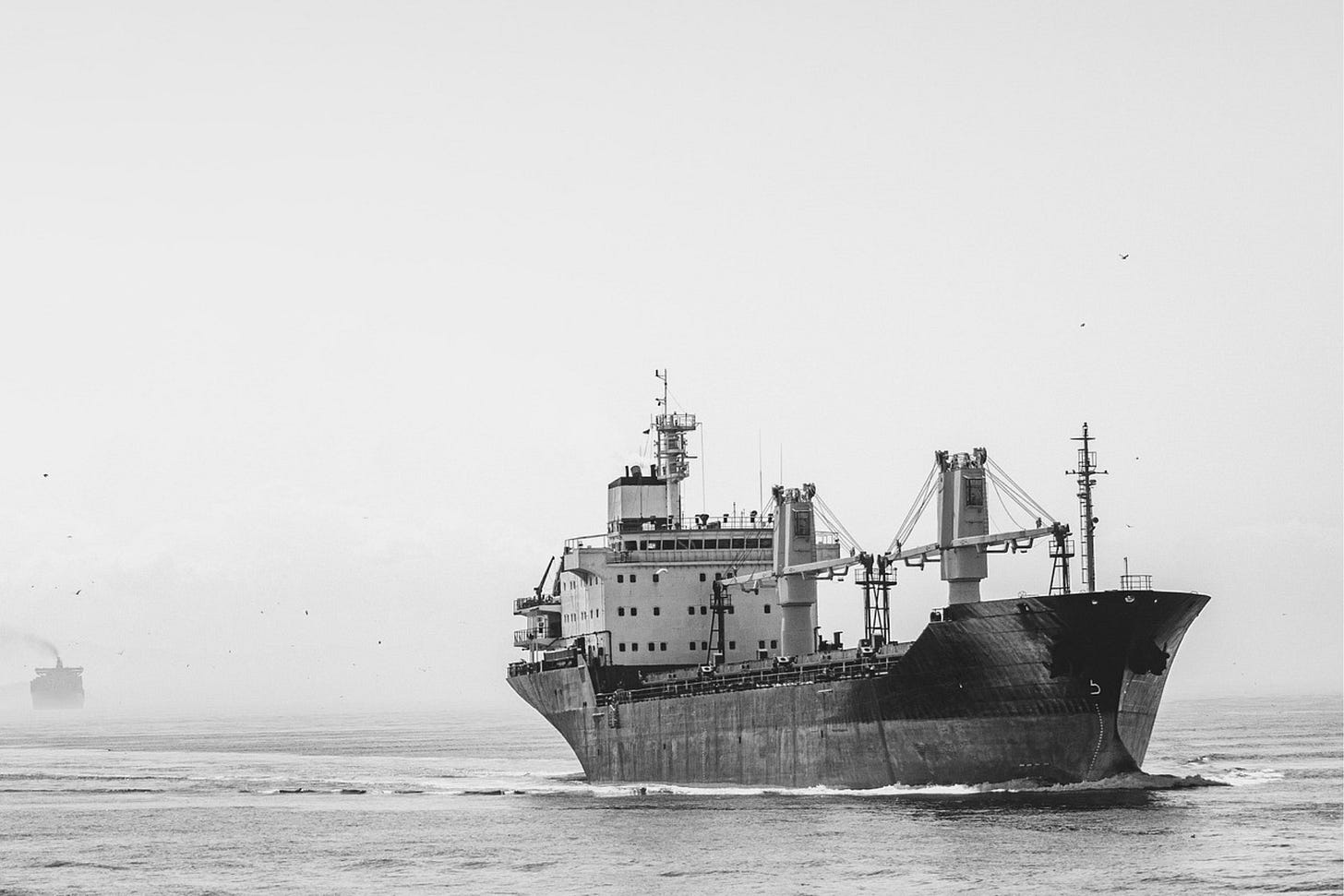 photo of a cargo freighter on the ocean