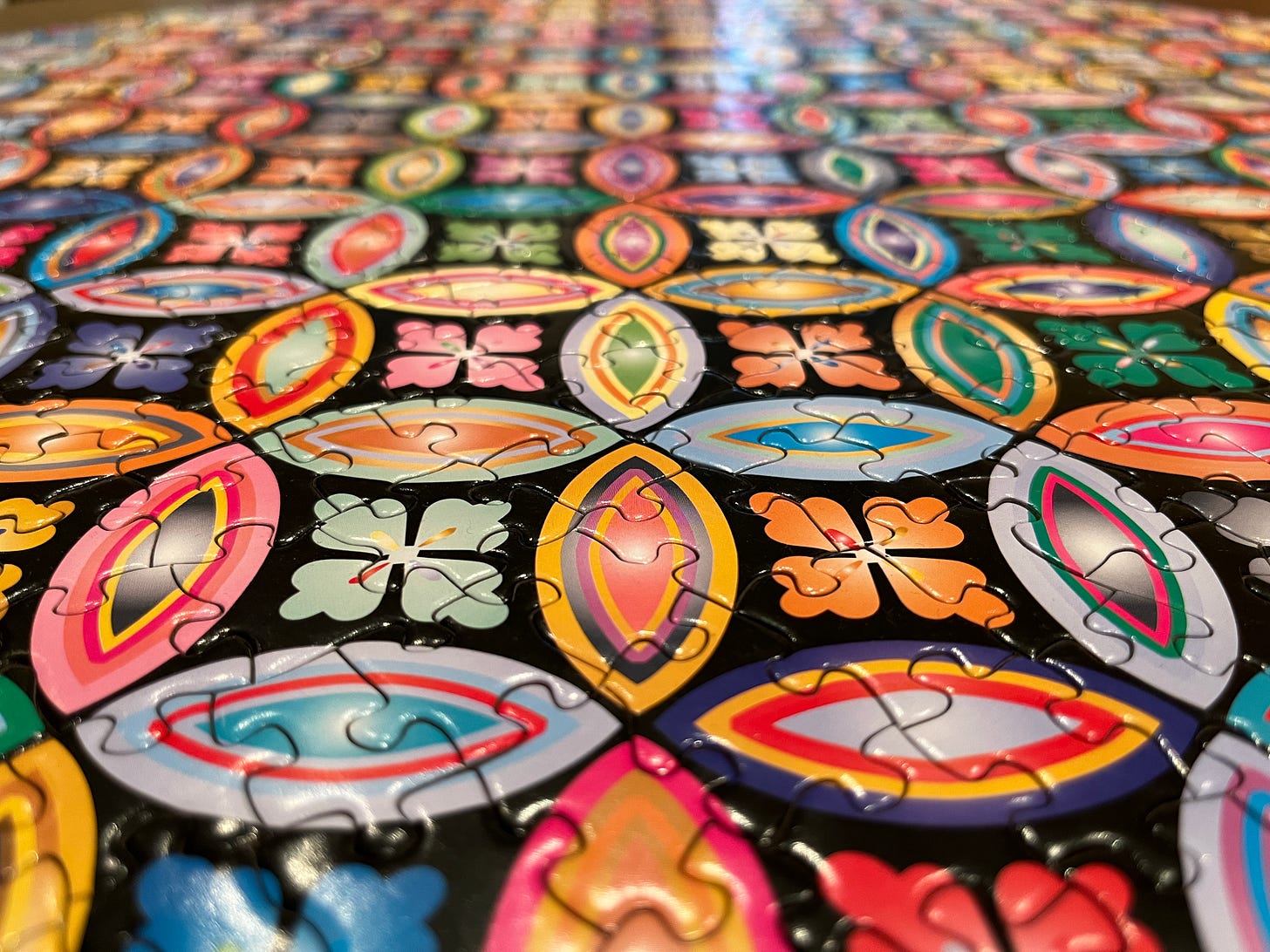 An assembled puzzle with geometric shapes and random colors
