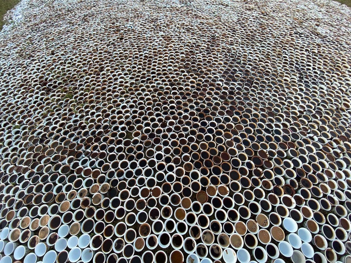An art installation featuring thousands of Bosnian coffee cups, each filled with coffee.