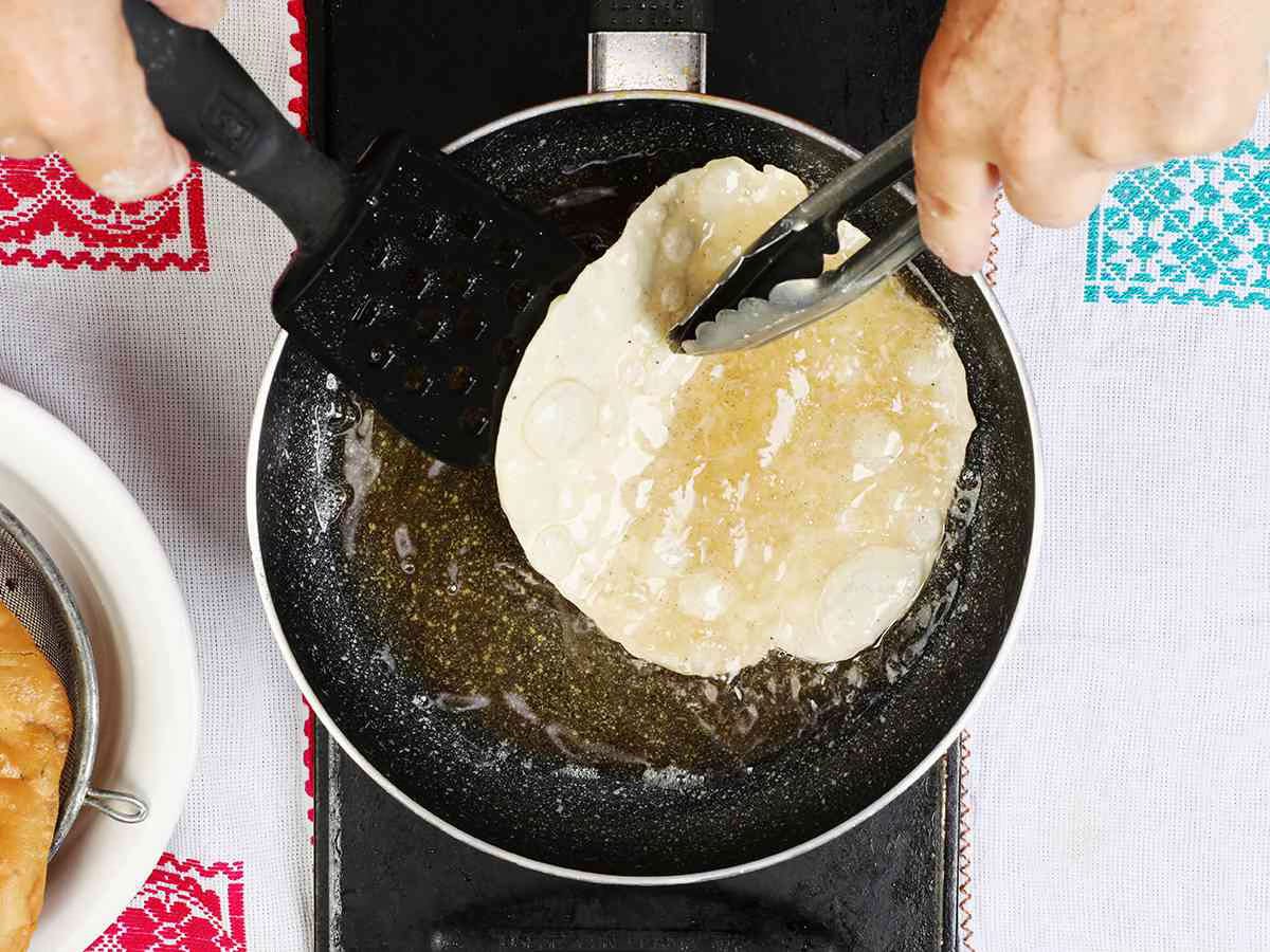 Flipping Buñuelo in Pan