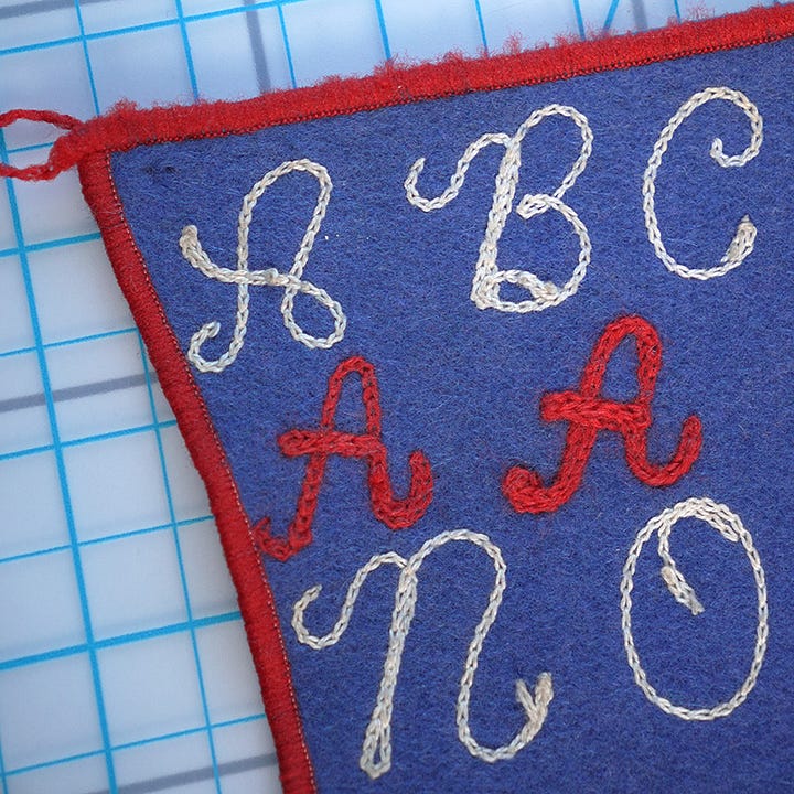 chainstitch alphabet on blue felt